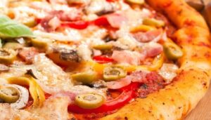 ham, mushroom and vegetable pizza and salami pizza at the back