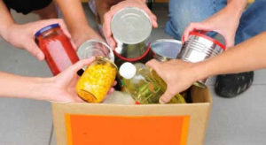 People putting food in a donation box