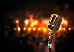 Single retro microphone against colourful background with lights